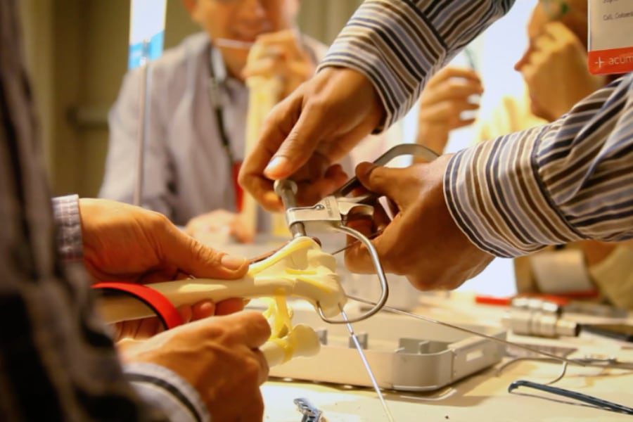 Doctors watching demonstration of crank on wrist bones