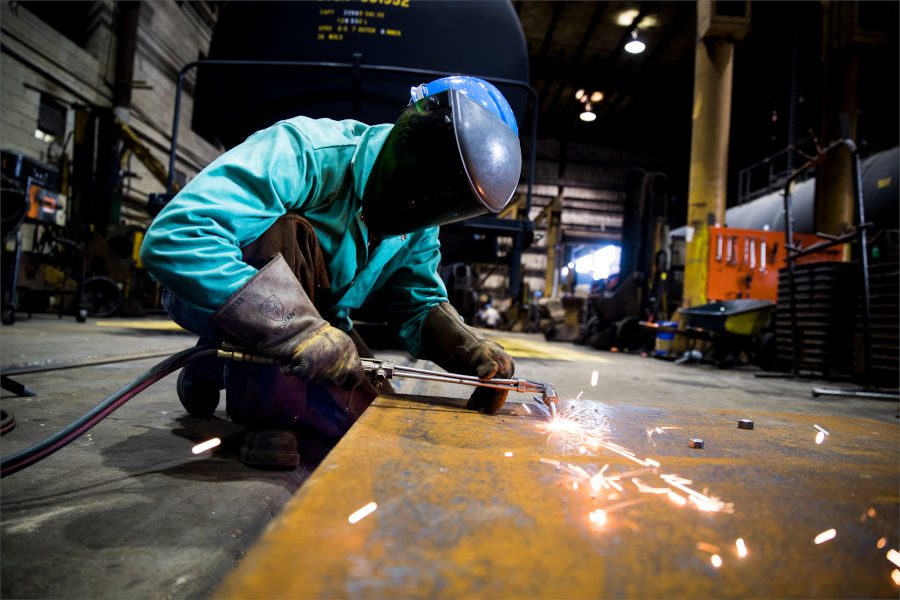 Welder working on piece of metal