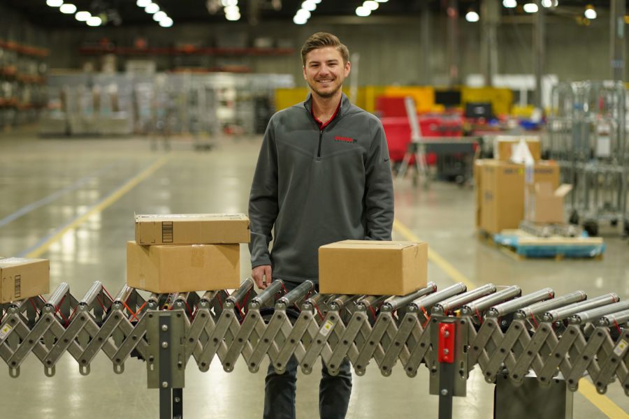 Male working on conveyor belt with multiple sizes of boxes