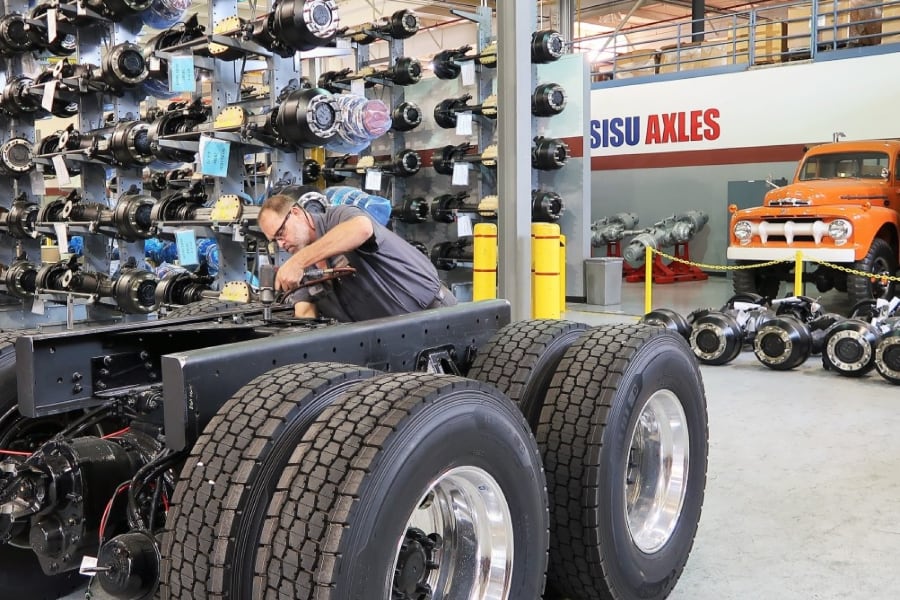 Male mechanic working on trailer tires