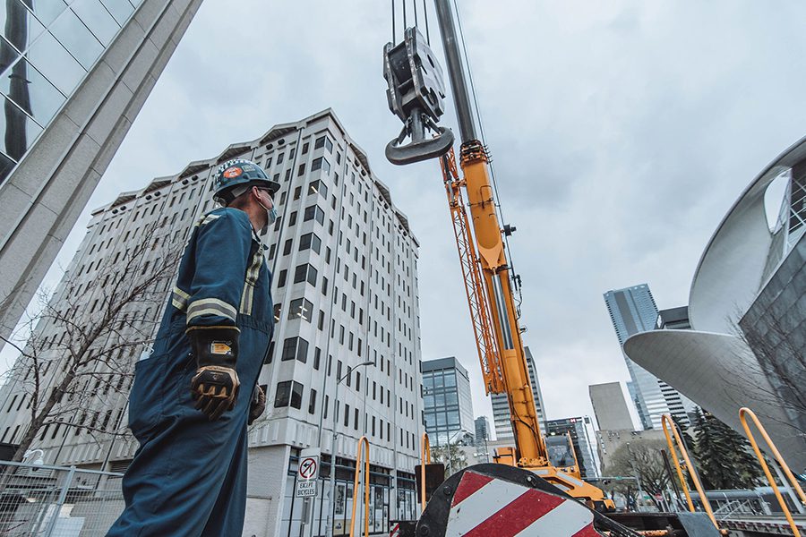 Sterling Crane employee_ ooking at crane in construction site