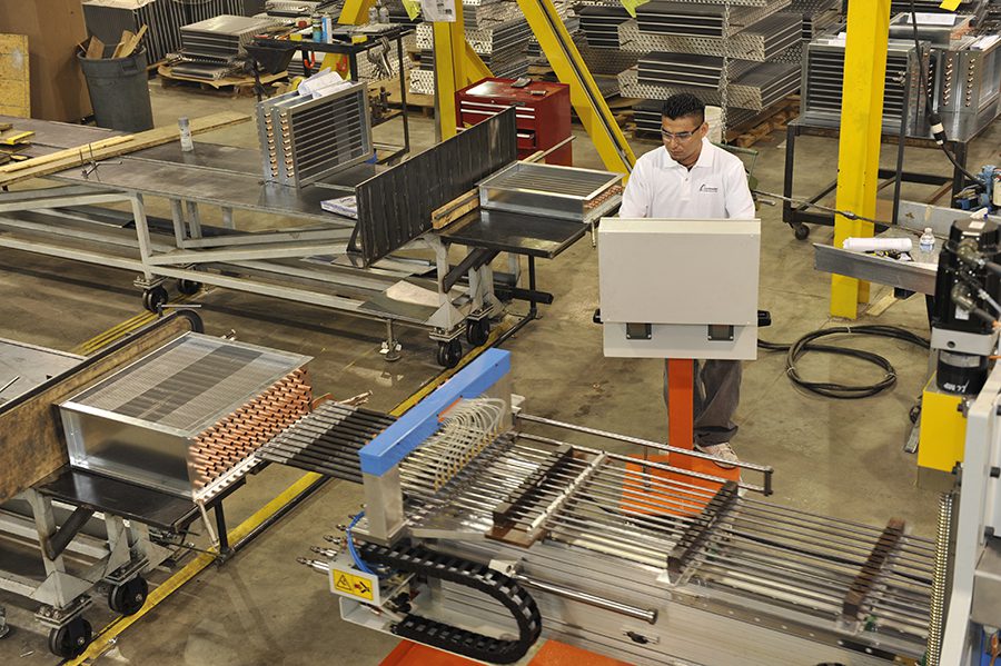 Employee at work in Coilmaster production facility.