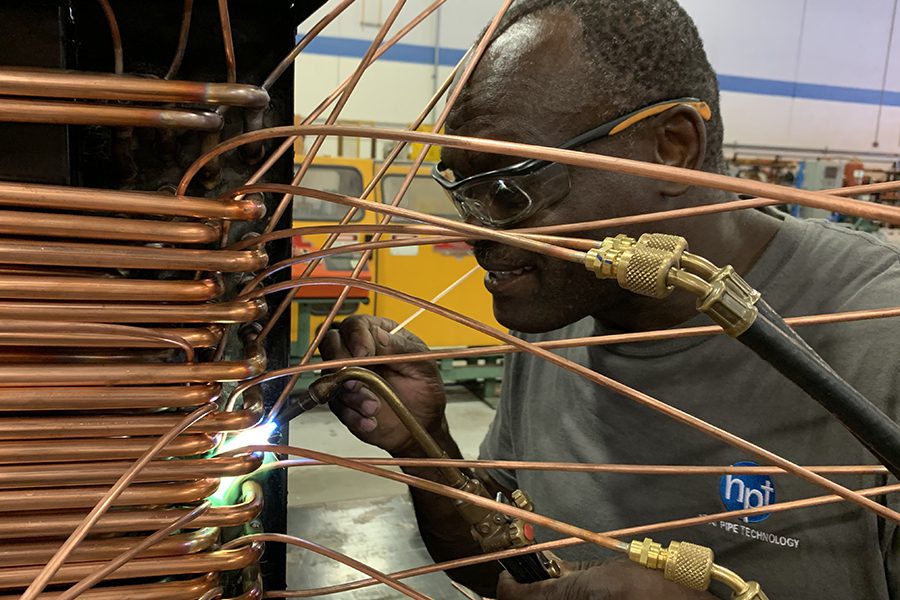 Plumbing_&_Refrigeration_Heat_Pipe_Technology_Inc._IMG_3284 Heat Pipe Technology employee at work on copper pipe
