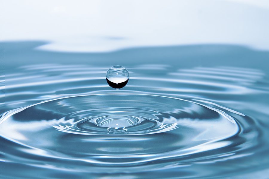 water droplet surrounded by ripples