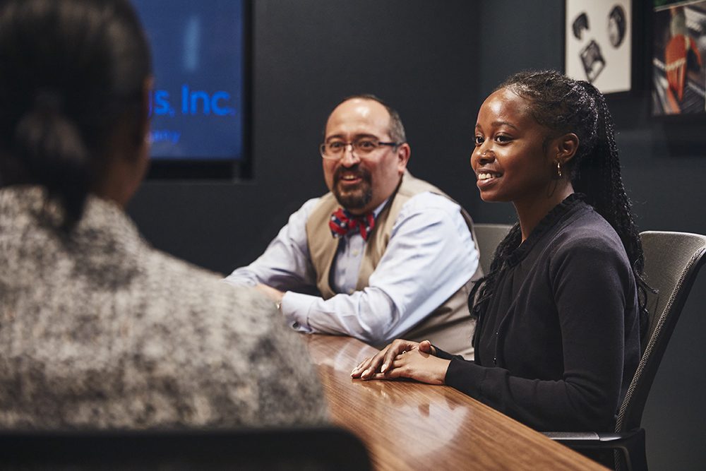 Employees working around a conference table