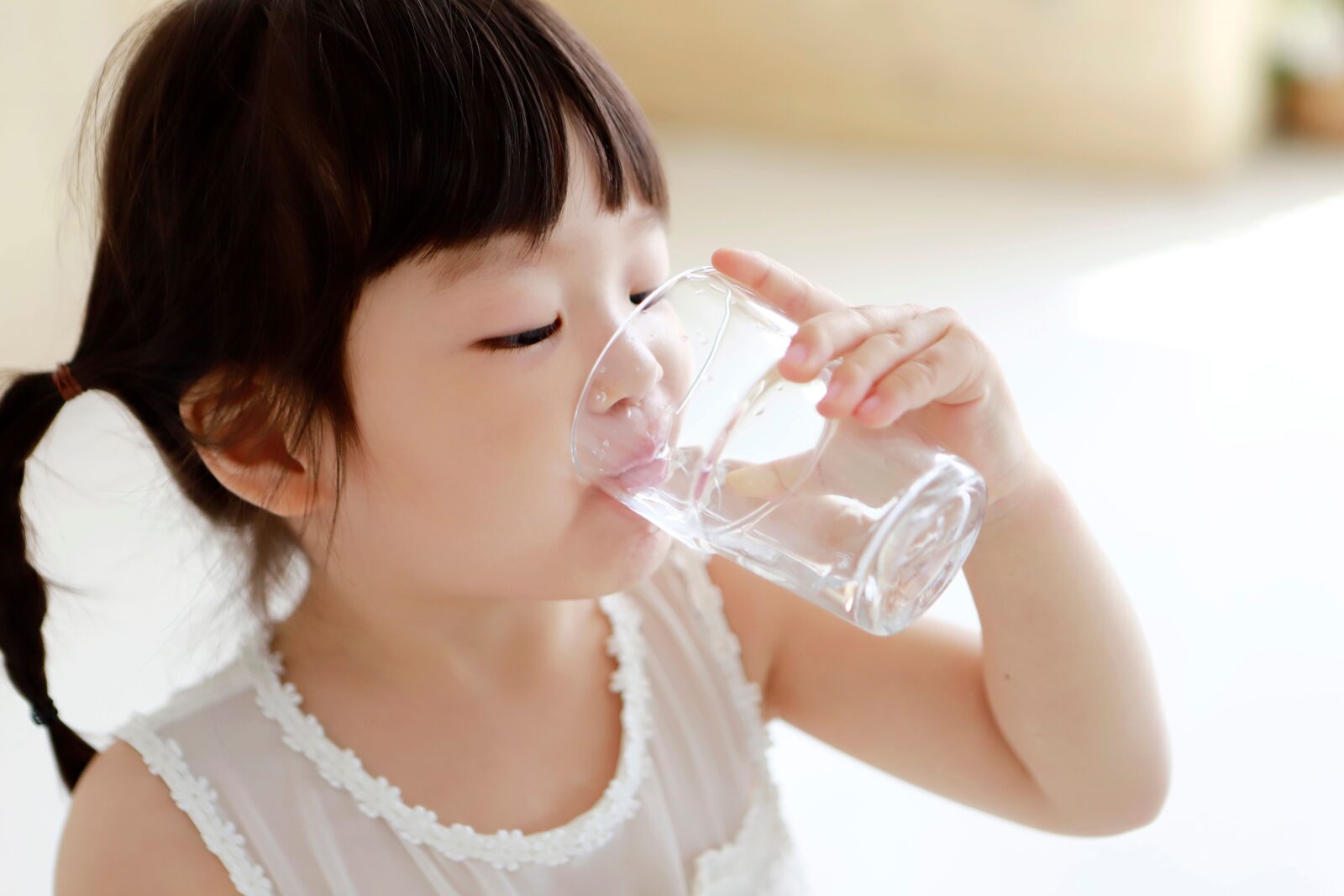child drinks clean water