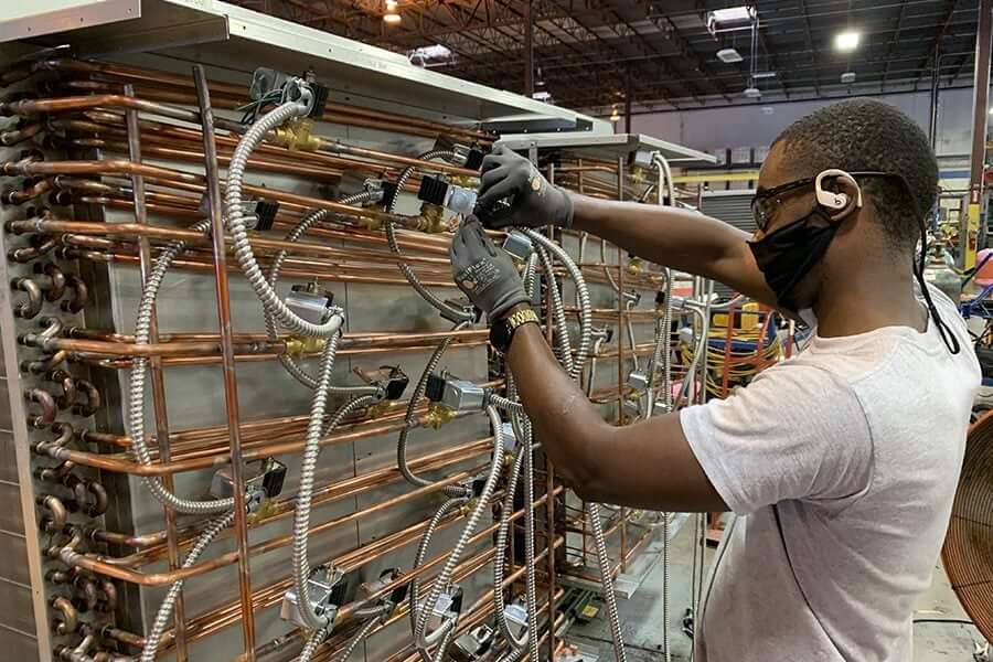 Heat Pipe Technology Inc. employee at work on coper tubing
