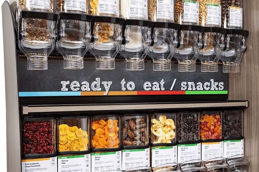 Snack display from Trade Fixtures filled with various dried fruits and nuts