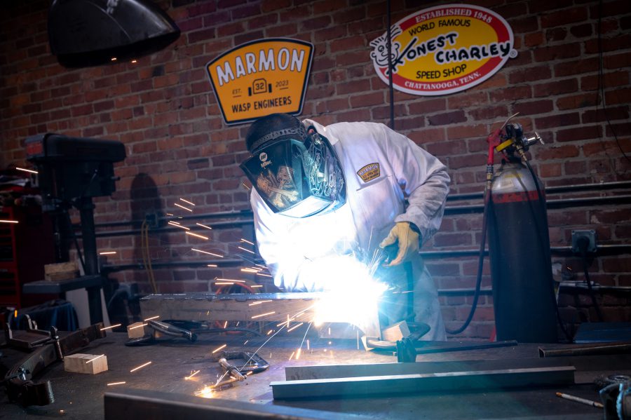 Engineer welding a part for the Wasp replica car