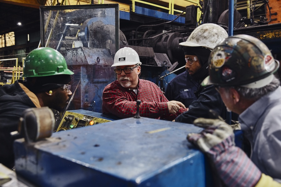 three men in masks at car collaborating