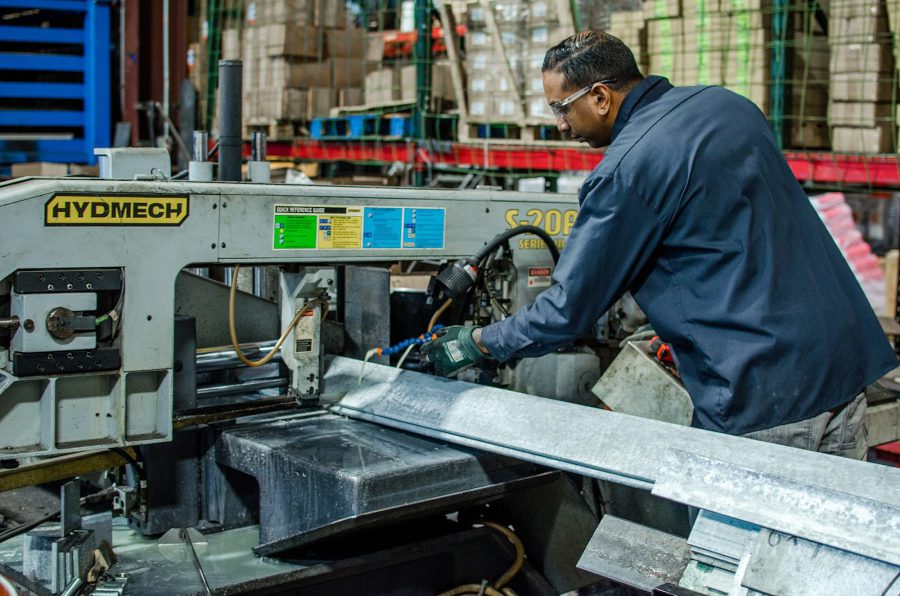 Hohman-and-Barnard Male industrial employee cutting metal