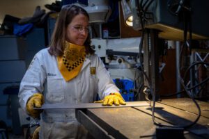 Woman cutting metal