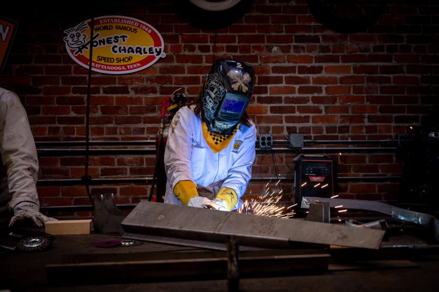 Wasp engineer welding a part for the replica car.